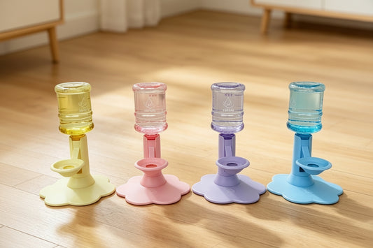 Four reusable water bottle adapters in pastel yellow, pink, lavender, and blue, arranged on a wooden floor with promotional text above.