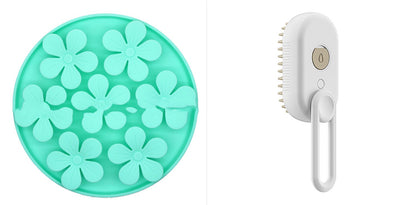 Mint green flower-shaped object and white handheld brush on a white background