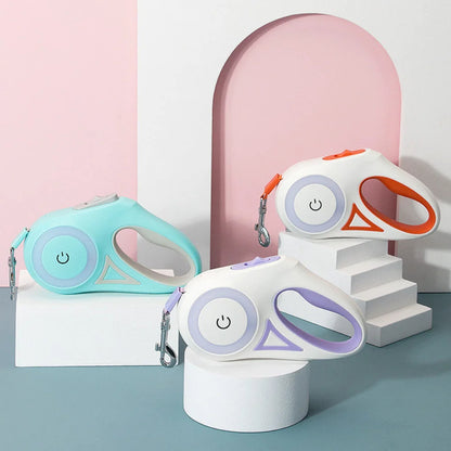 Two colorful pet leashes on cylindrical stands against a pink and gray background