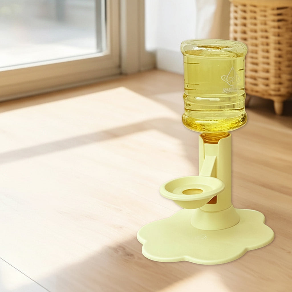 Yellow automatic water dispenser bottle holder with a flower-shaped base, shown on a wooden floor in a bright room. The image includes a product inset showing included accessories like a straws brush, suction cup, and transparent sticker.